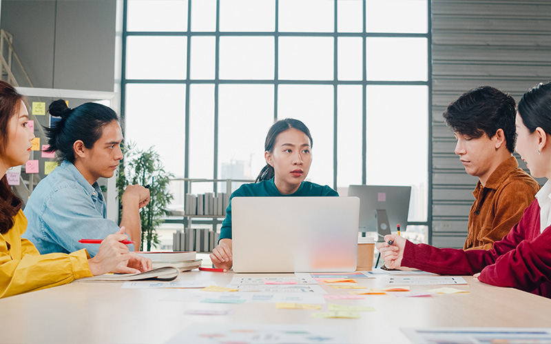 A group of professionals holding a meeting in a modern office