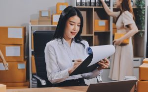 Logistics manager arranging corporate bus transport services for business.