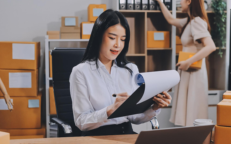 Logistics manager arranging corporate bus transport services for business.